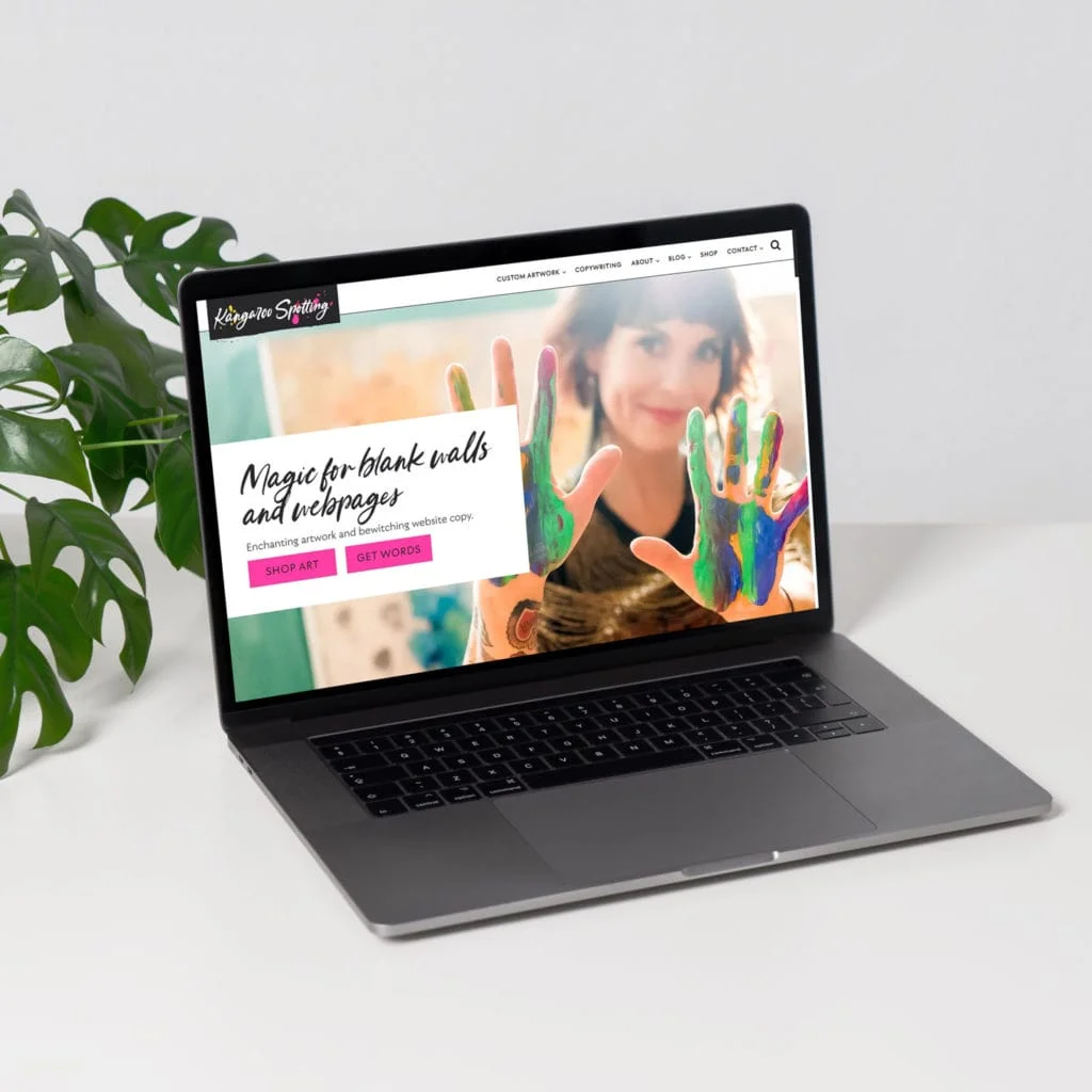 A laptop displaying a website for a copywriter.
