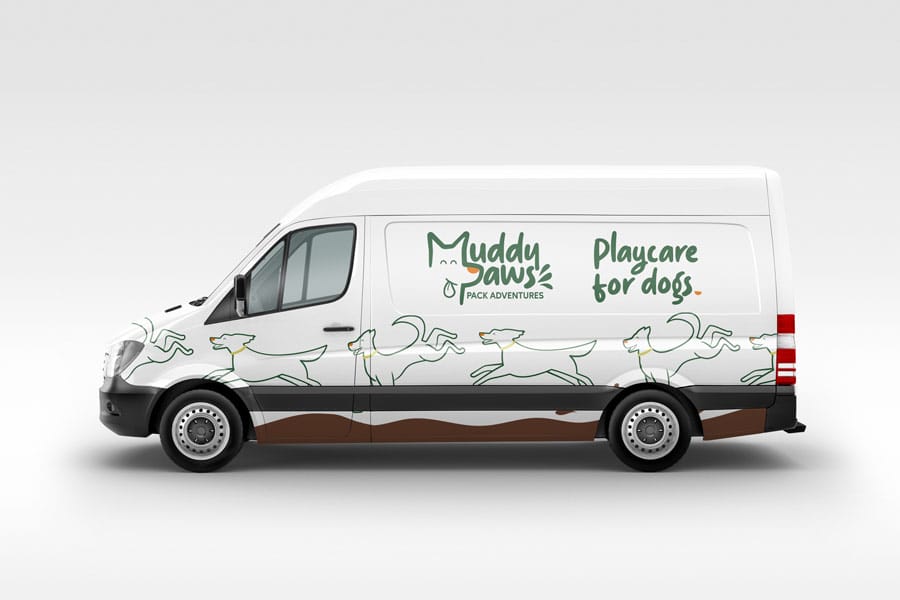 A white van with the words muddy play for dogs on it, featuring a brand design logo prominently displayed.