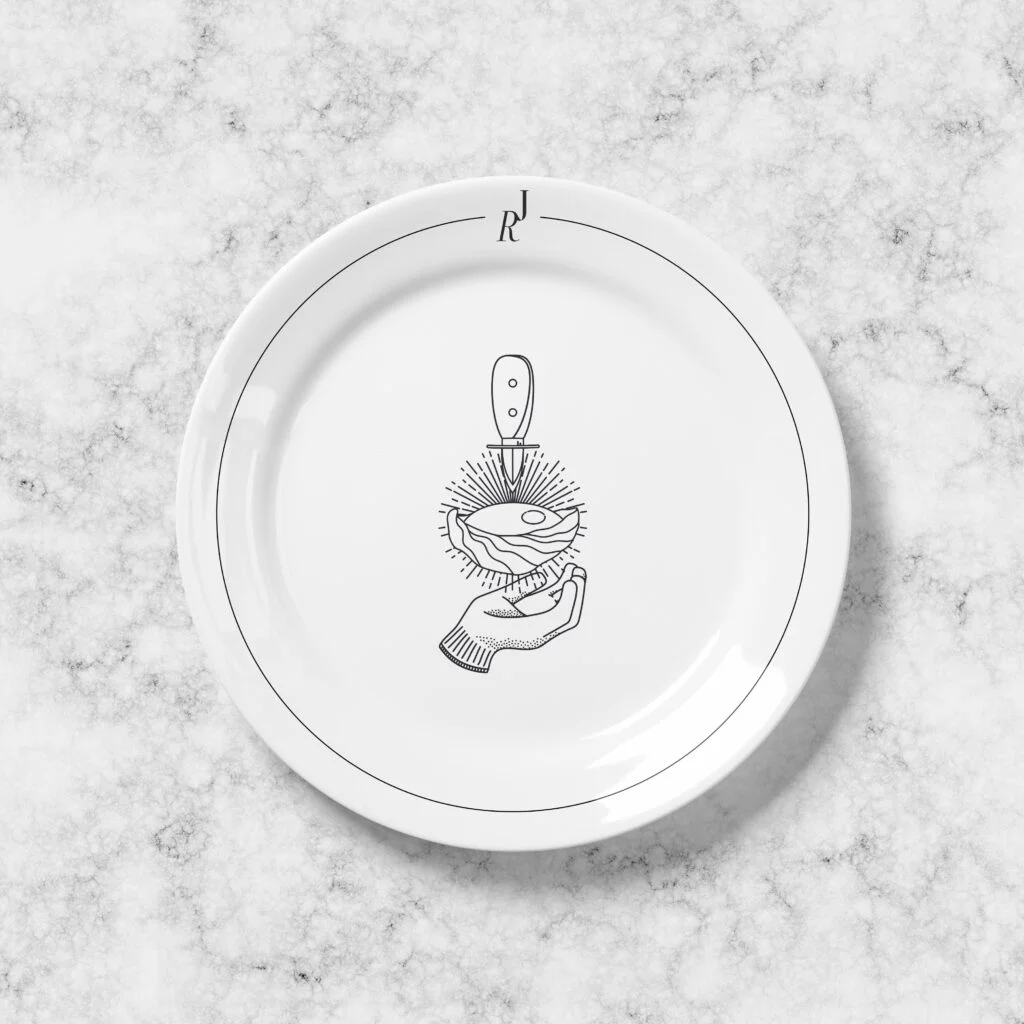a plate with a drawing of a hand holding a spoon.