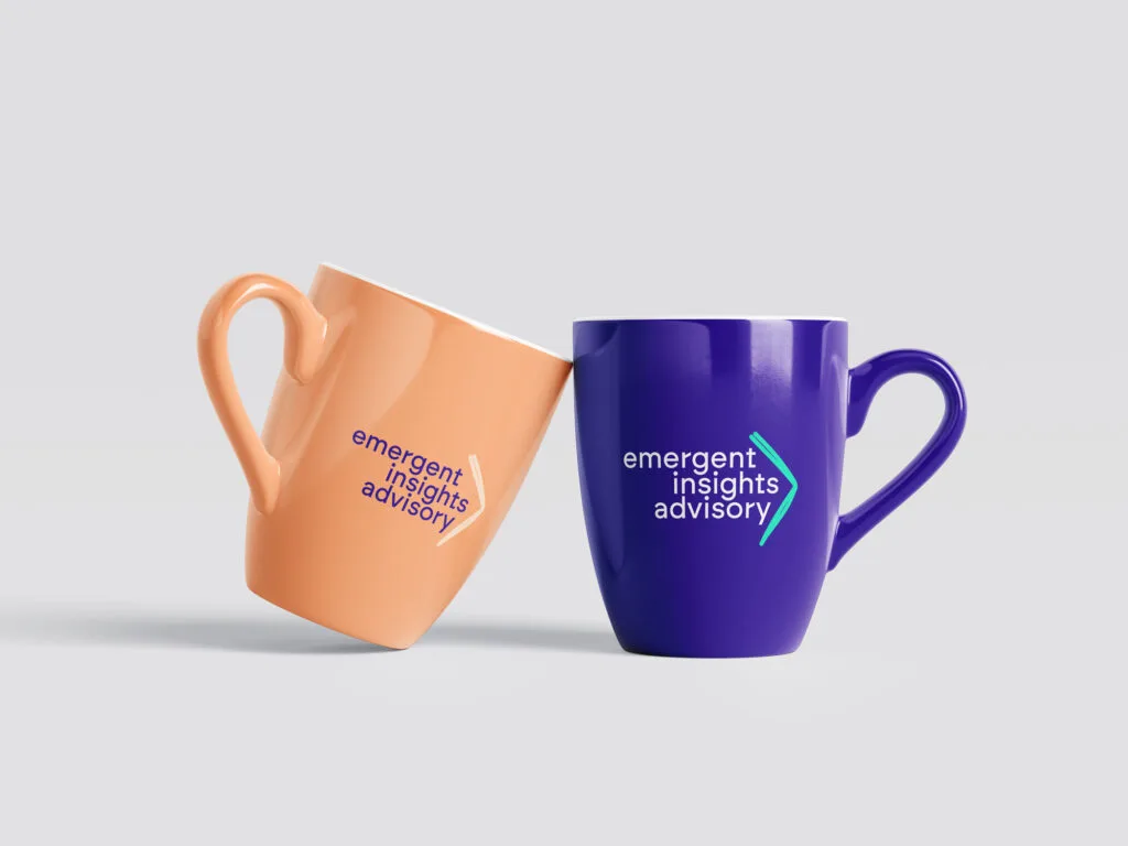 two coffee mugs tilted toward each other. one is orange and the other is blue, both with "emergent insights advisory" logo.