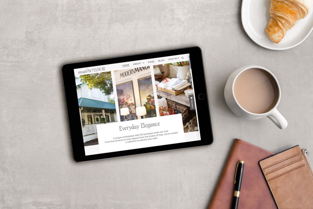 Tablet displaying Modern Manor boutique website with coffee and croissant